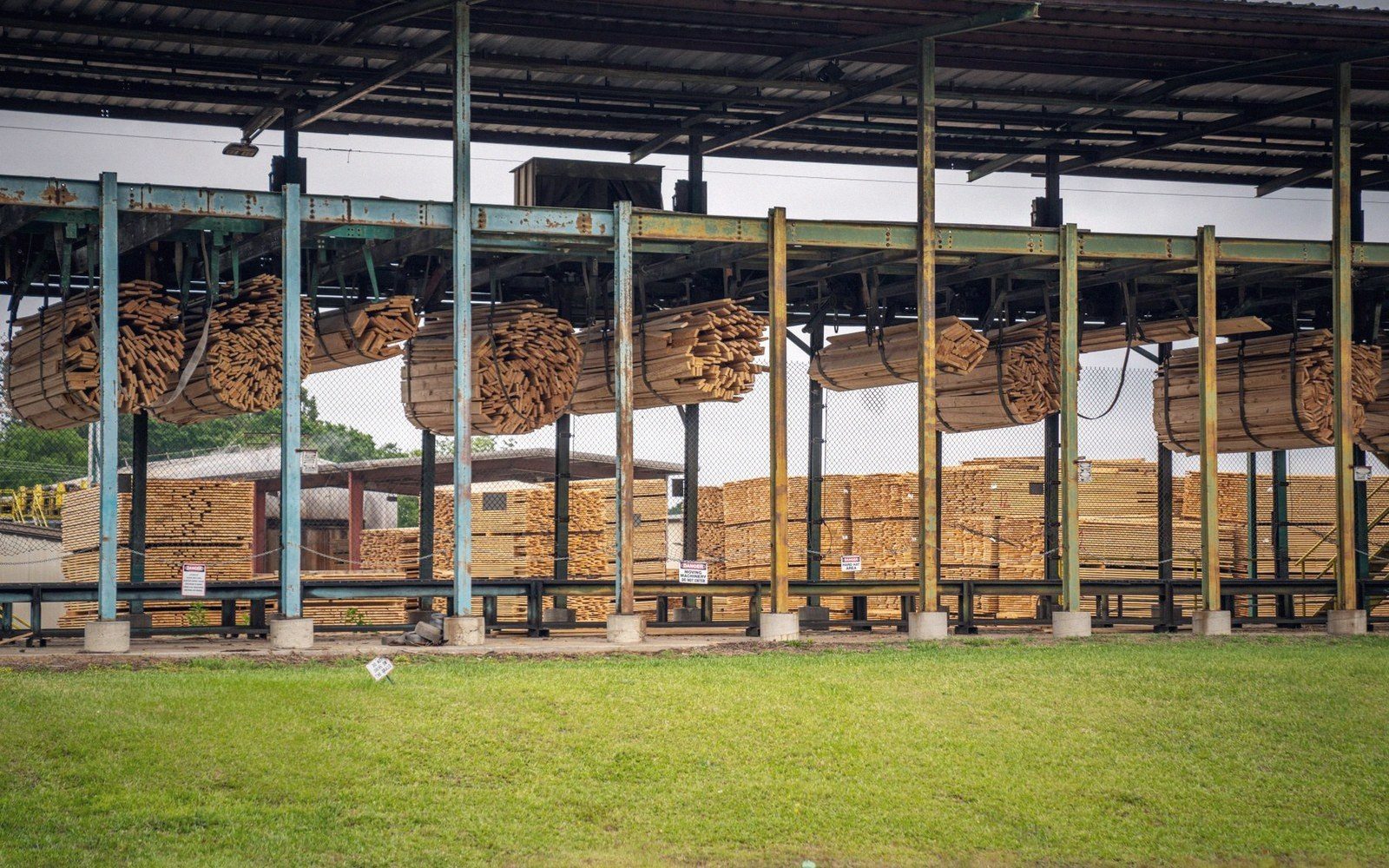 Bundled timber and stacked lumber under a covered mill structure